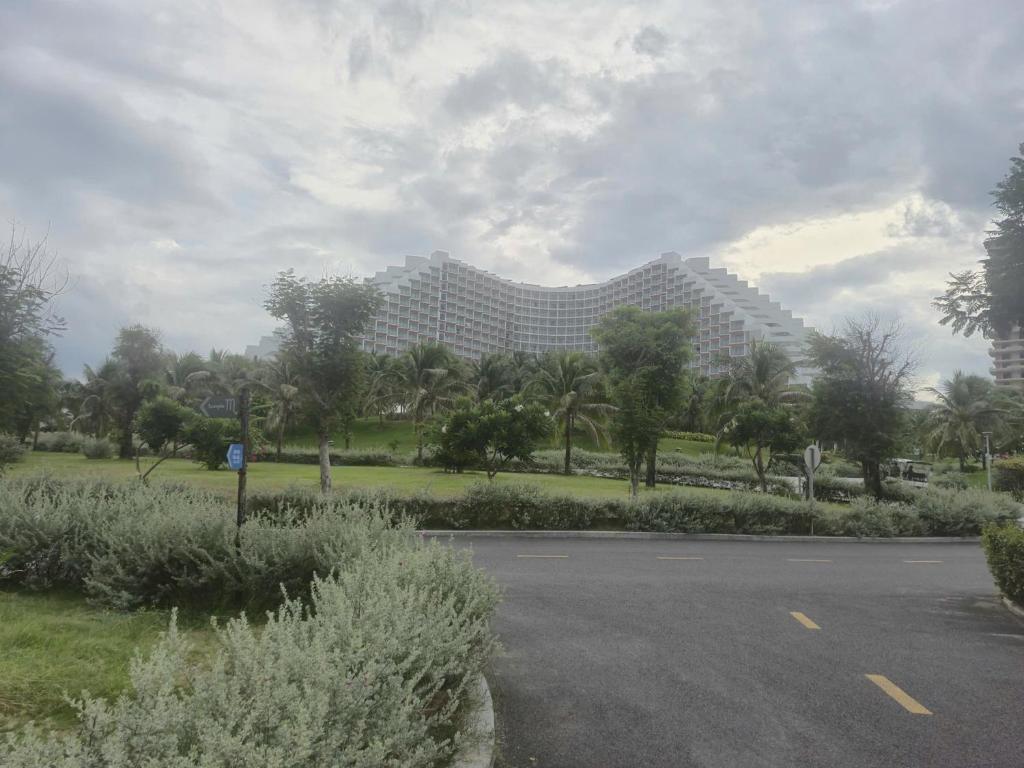 a large building in the distance with a parking lot at Arena Lucky Condotel in Cam Ranh International Airport