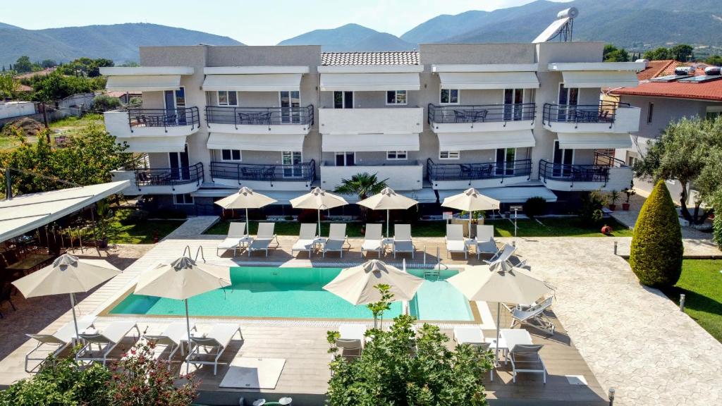 an image of a hotel with a pool and umbrellas at Littore Maris in Nea Vrasna