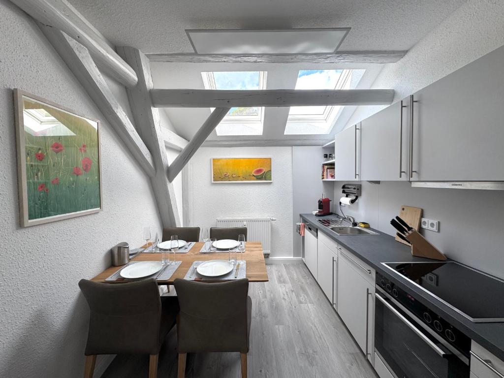 a kitchen with a table and chairs in a room at Brauhaus Suite 16 in Sebnitz