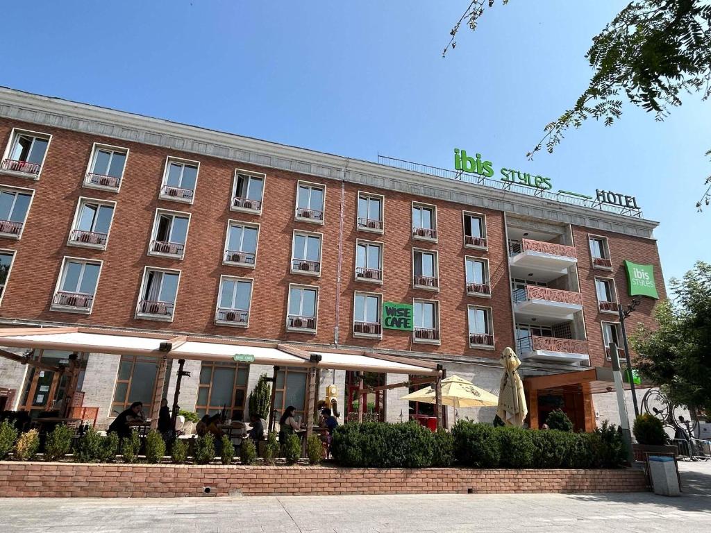 a large red brick building with a sign on it at ibis Styles Dunarea Galati in Galaţi