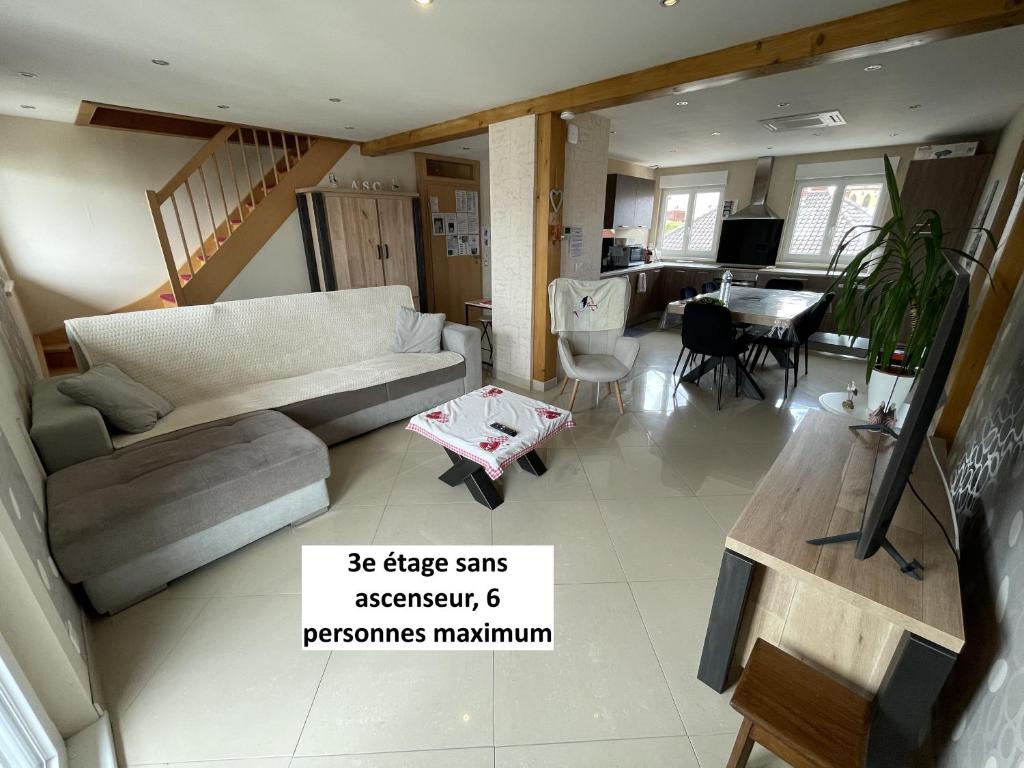 a living room with a couch and a table at Appartements centre ville Colmar 4 familles in Colmar