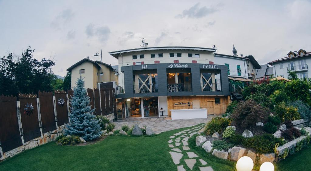 a large house with a christmas tree in a yard at La Filanda Relax&Gourmet in Denno