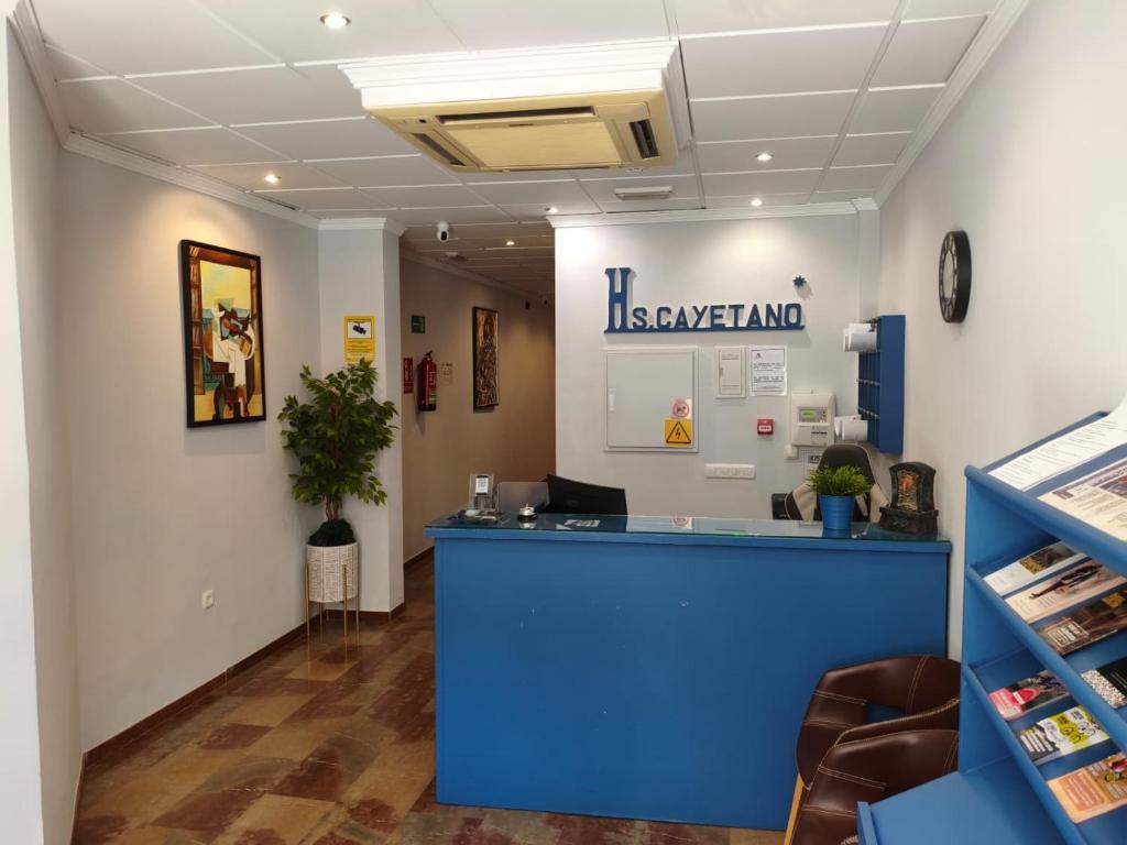 an office with a blue counter in a room at Hostal San Cayetano in Ronda