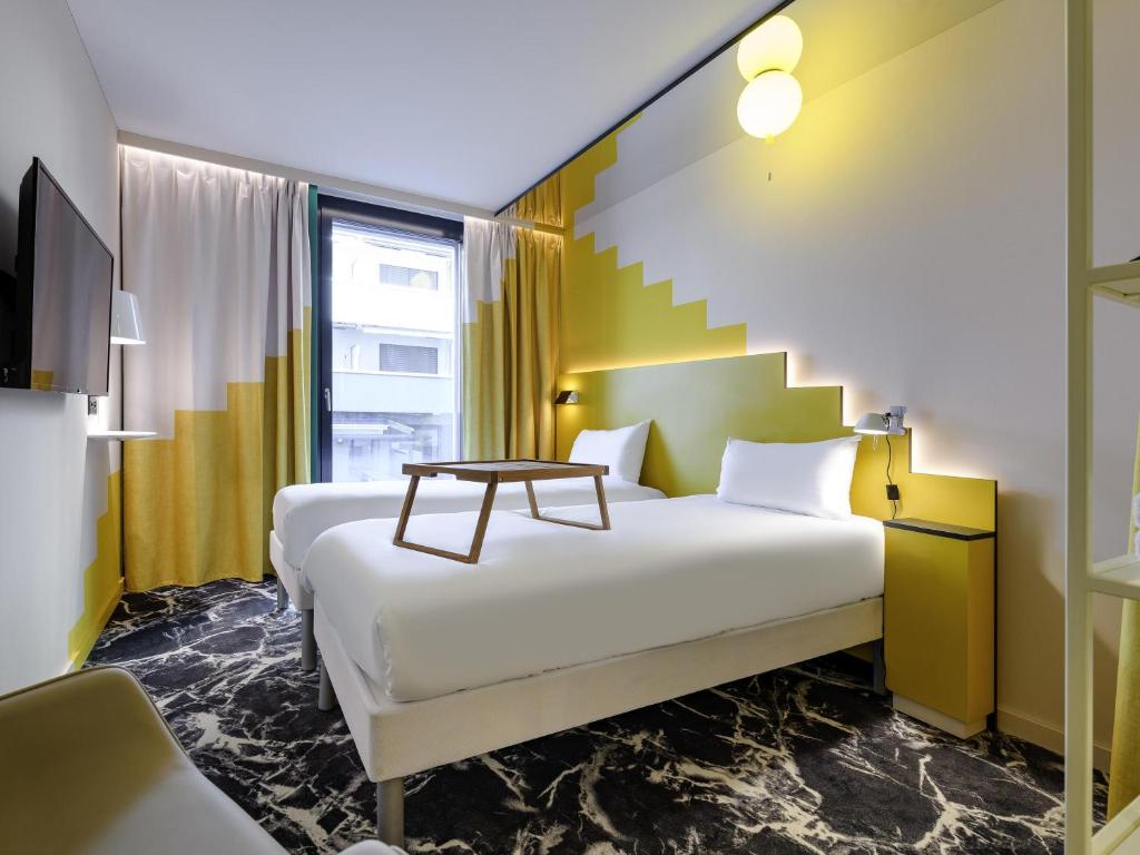 a hotel room with a bed and a staircase at ibis Styles Zurich City Center in Zurich