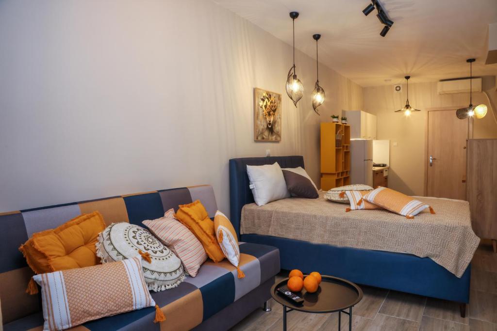 a living room with a couch and a bed at Cozy Twins - Terra in Kavála