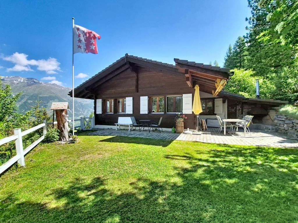 a house with a flag in the yard at Chalet Himmulriich by Interhome in Gasenried