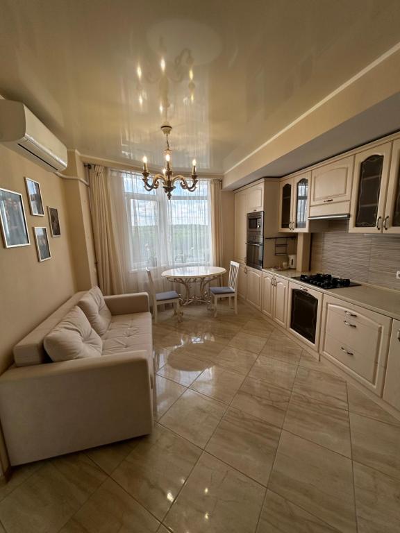 a living room with a couch and a table at Classic Contemporary Apartament in Chişinău