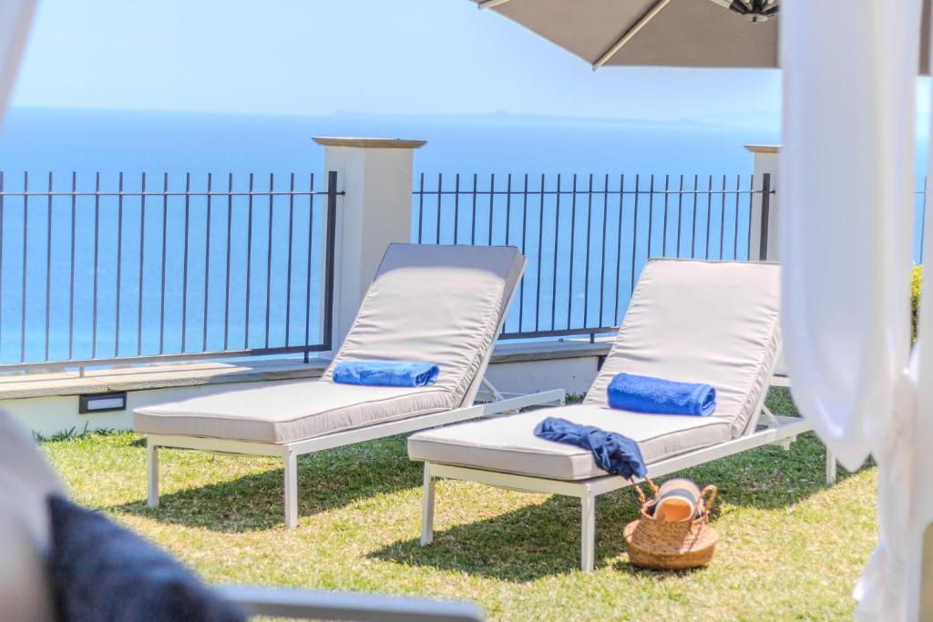 two lounge chairs sitting on a balcony with at Villa Greta in Porto San Giorgio