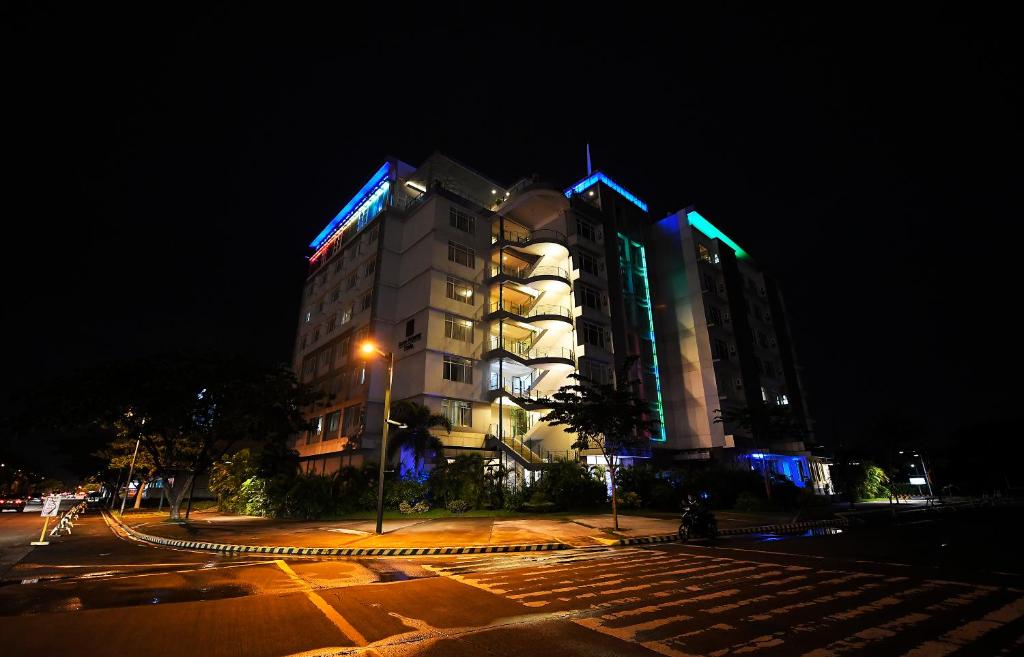 a tall building with blue and green lights on it at Paseo Premiere Hotel in Santa Rosa