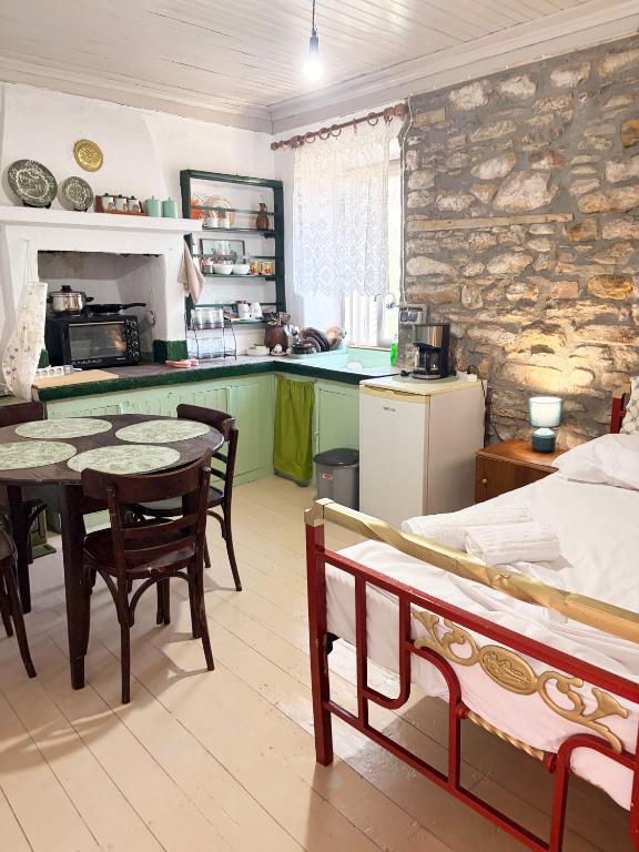 a kitchen with a table and chairs in a room at Thassos Traditional House in Limenaria