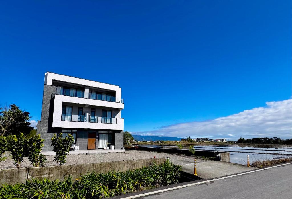 a building on the side of a road next to a river at 根本家民宿 in Dayi