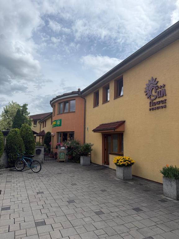 a building with a bike parked in front of it at Penzión Sunflower in Piešťany