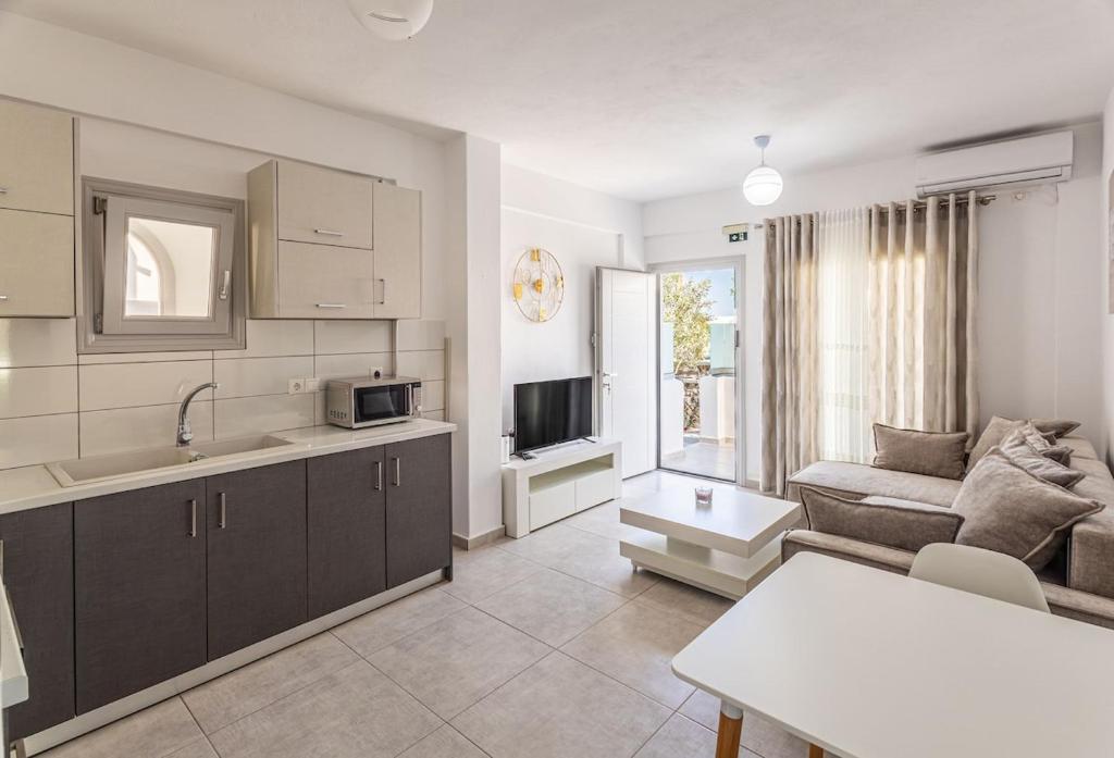 a kitchen and living room with a couch and a table at Ageri Suite II in Vóthon