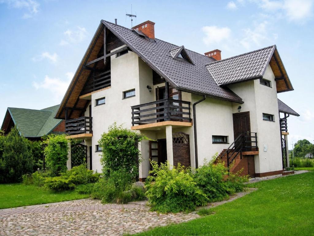 a large white house with a black roof at Willa Sara in Okuninka