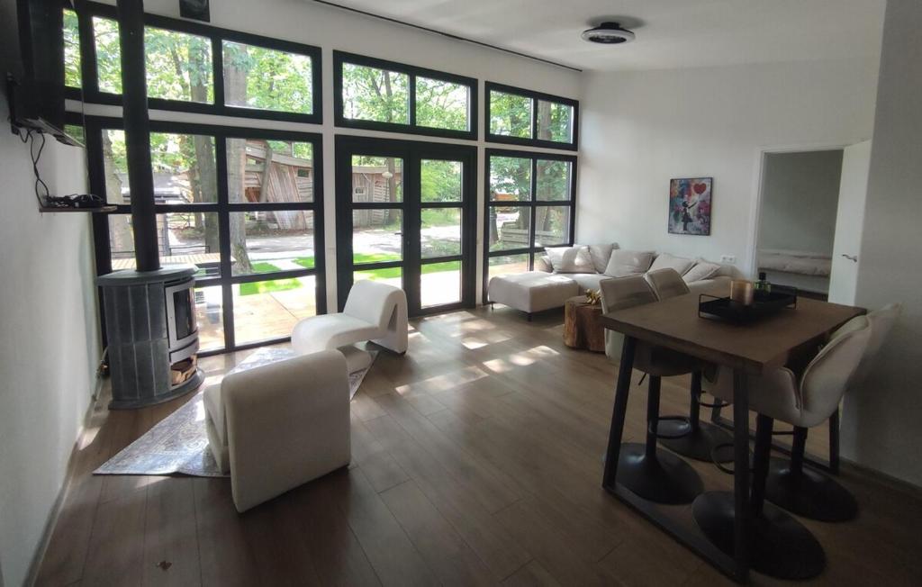 a living room with a couch and a table at Luxe chalet midden in de natuur in Rijen