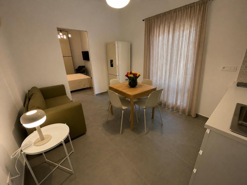 a living room with a couch and a table at Moon Apartments A in Soverato Marina