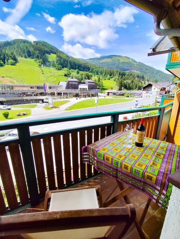 a table on a balcony with a view at Appartements Haus am Römerbad Bad Kleinkirchheim in Bad Kleinkirchheim