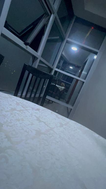 a room with a white table and a chair at Acactus in Kampala