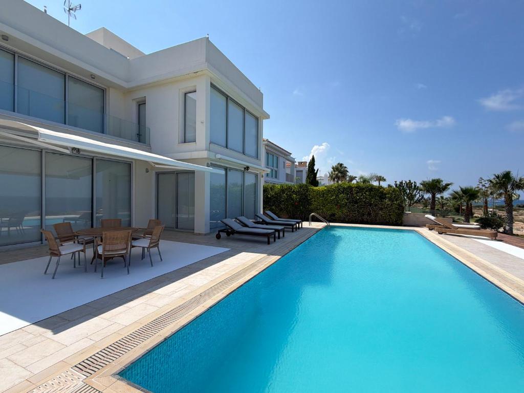 a swimming pool in the backyard of a house at Nireas Crystal in Aglantzia