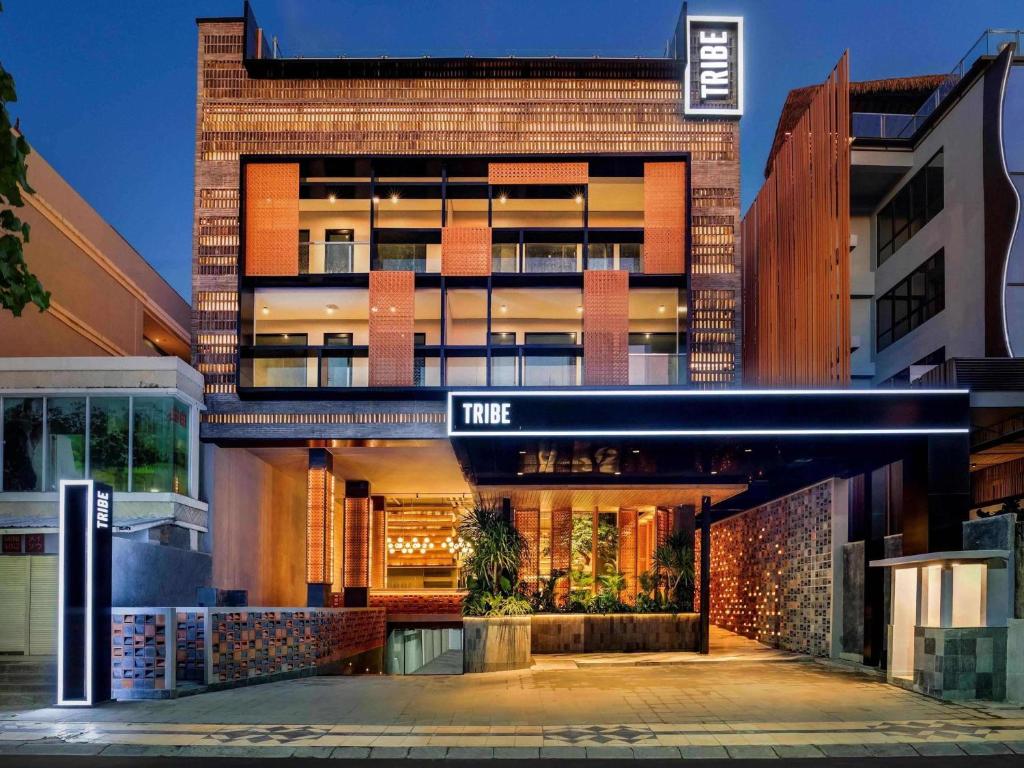 a brick building with a sign that reads true at Tribe Bali Kuta Beach in Kuta