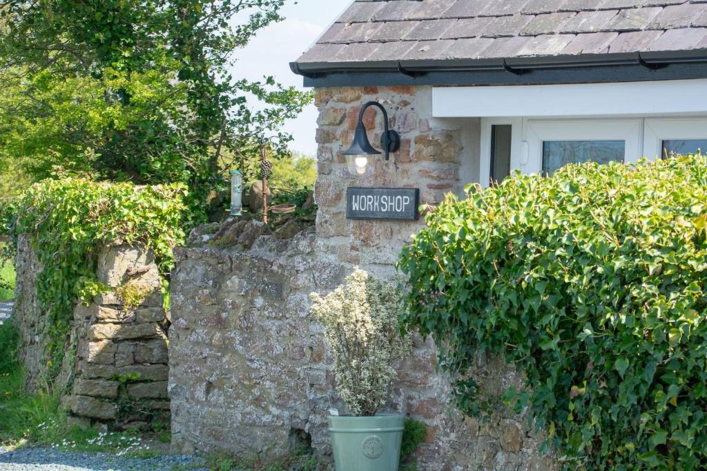 a house with a sign that reads main street at Cosy Hideaway I Couples Break I Private Estate in Newborough