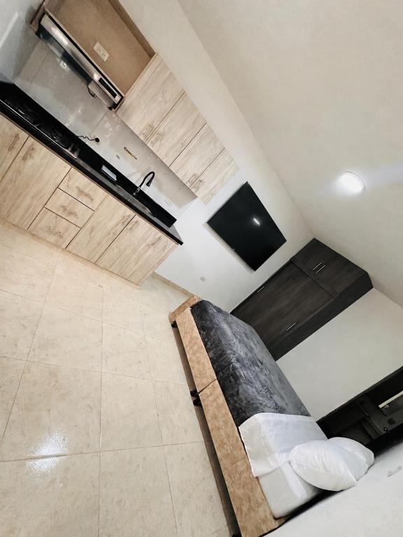 a room with a couch in the middle of a kitchen at Aluna Hotel, Laureles Medellín in Medellín