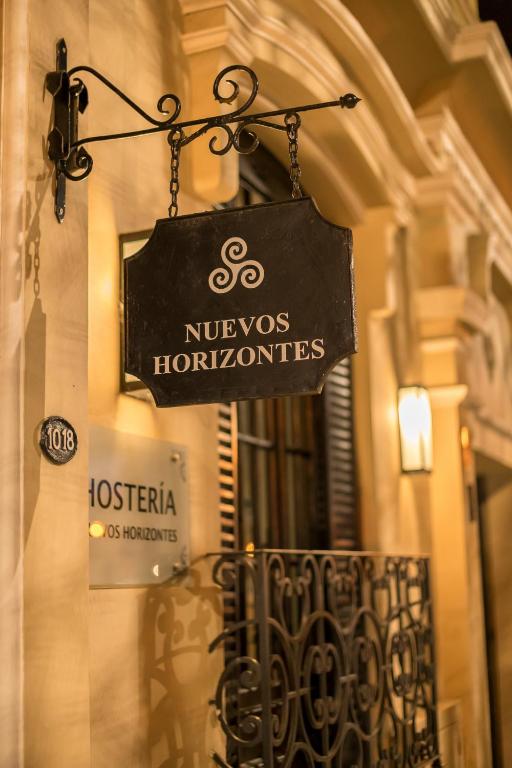 a sign hanging on the side of a building at Nuevos Horizontes in Tandil
