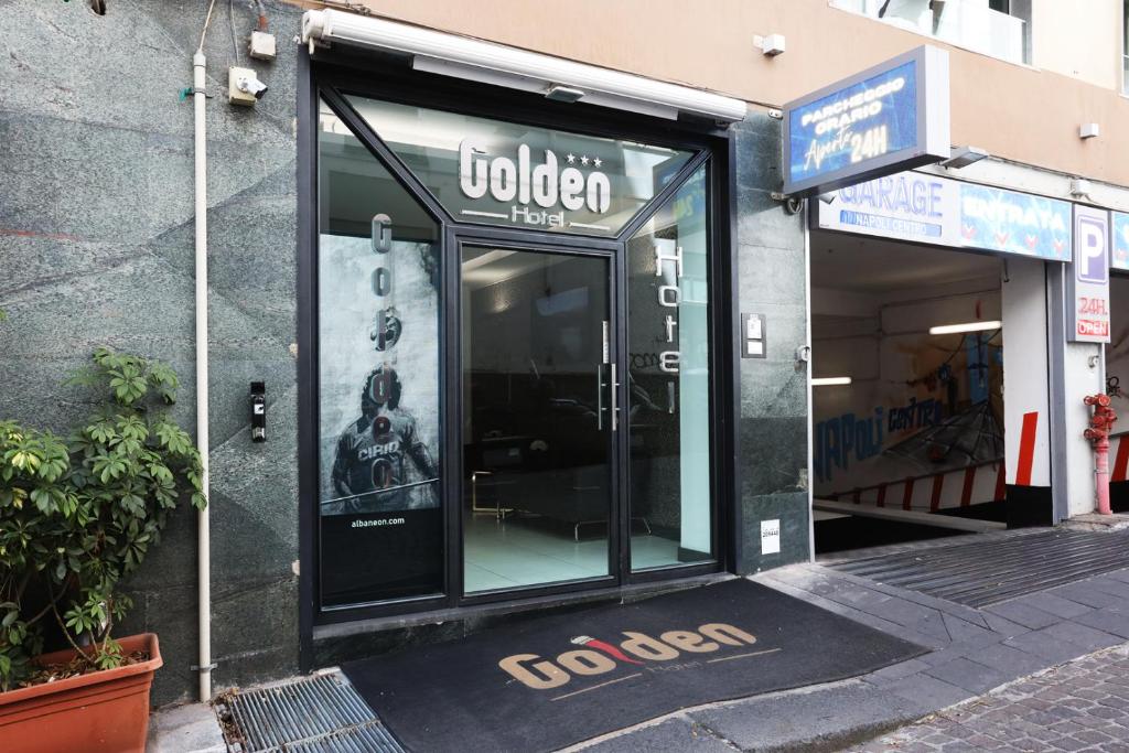 a store front with a glass door on a street at Golden Hotel in Naples