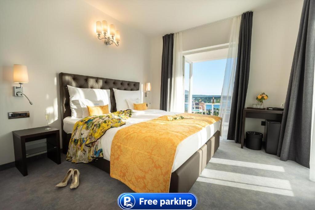 a hotel room with a large bed and a window at Villa Bellevue Portoroz-Portorose in Portorož