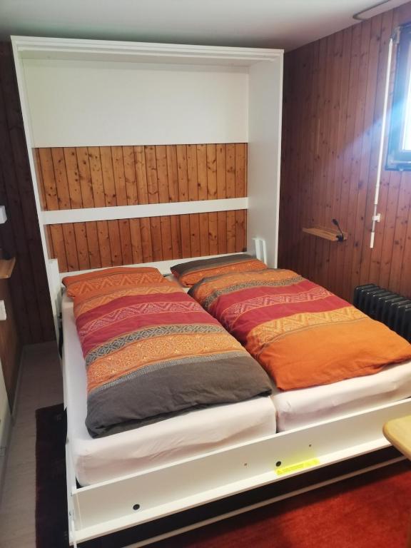 a bed with two pillows on it in a room at Alb-Refugium - beautiful, quiet in Schopfloch