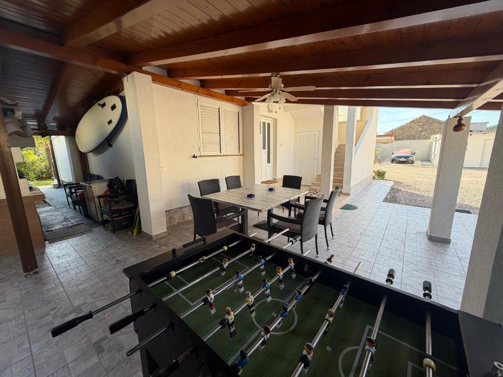 a dining room with a table with a soccer game on it at More Space, More Memories -Lana Rab Apartment in Rab