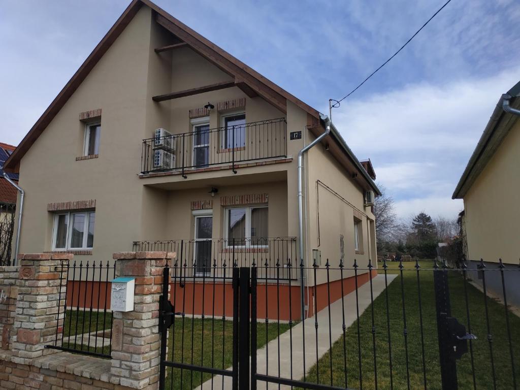 a house with a fence in front of it at BBFamily in Balatonboglár