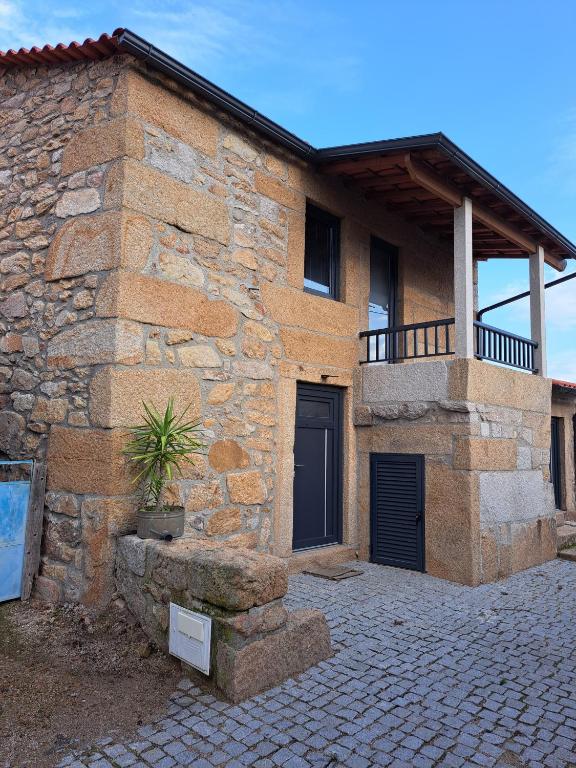 a brick house with a balcony on the side of it at A Casinha - By Marketignite in Barreira