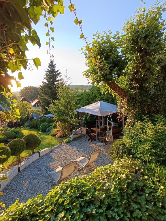 a gazebo with a table and chairs in a garden at Rustic Eden in Liptovský Mikuláš