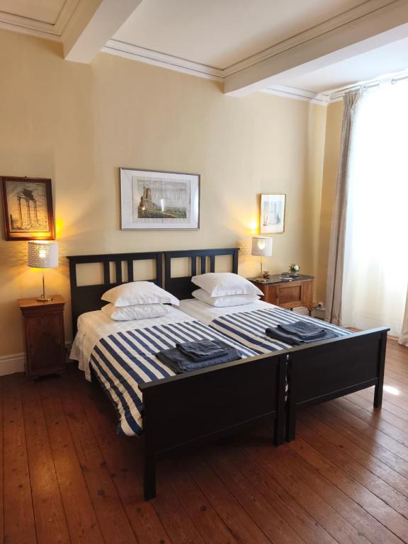 a bedroom with a large bed with two pillows at Ombre Rose in Le Fousseret