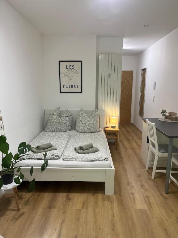 a bedroom with a bed and a table and chairs at Gemütliche Wohnung in Passau in Passau