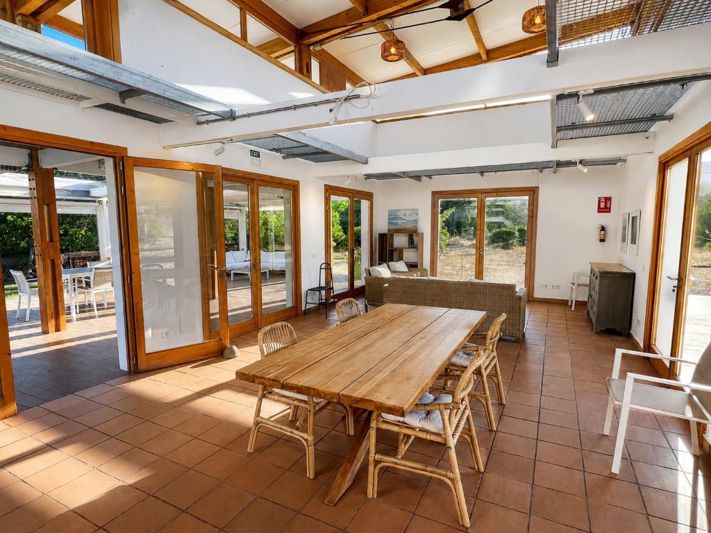 a large room with a wooden table and chairs at Finca Tramuntana in Palma de Mallorca