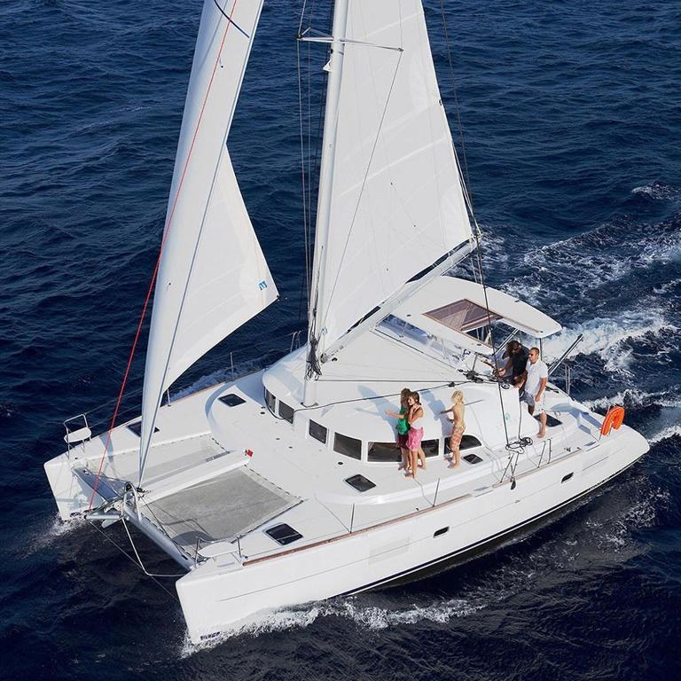 a group of people on a sailboat in the water at Barco apartamento in El Portil