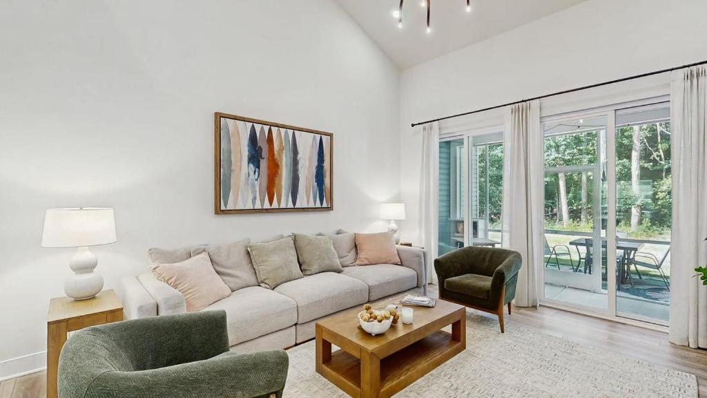a living room with a couch and two chairs at Milos Haven house with community pool in Frankford