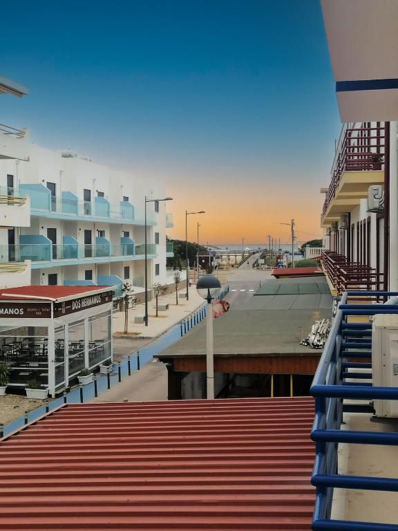 a view of a street with a beach and buildings at Casa Vila Rosa - T1 Altura Beach in Altura