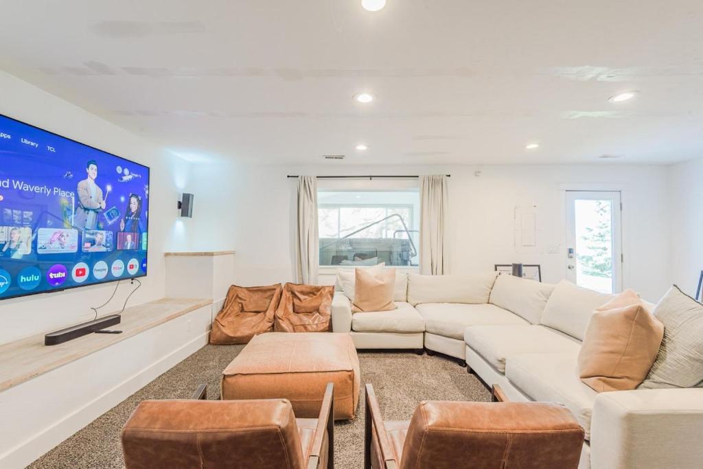 a living room with a white couch and a tv at 72 S Orem Entire Home in Orem