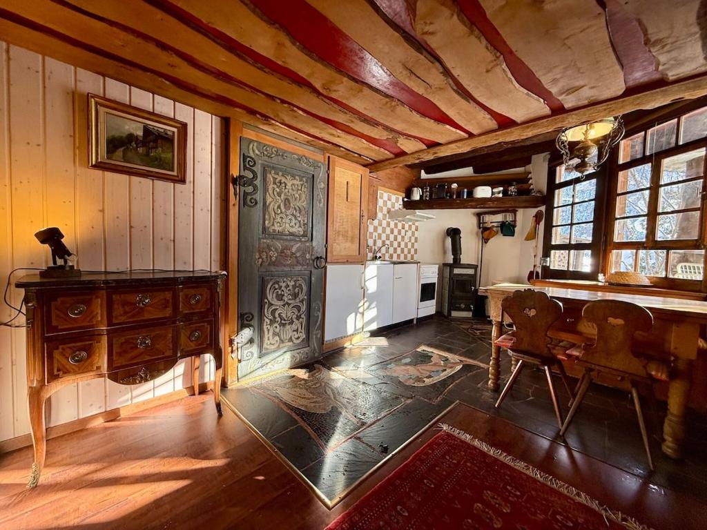 a living room with a table and a kitchen at Le Mazot des Révines - 2 pers in Champéry