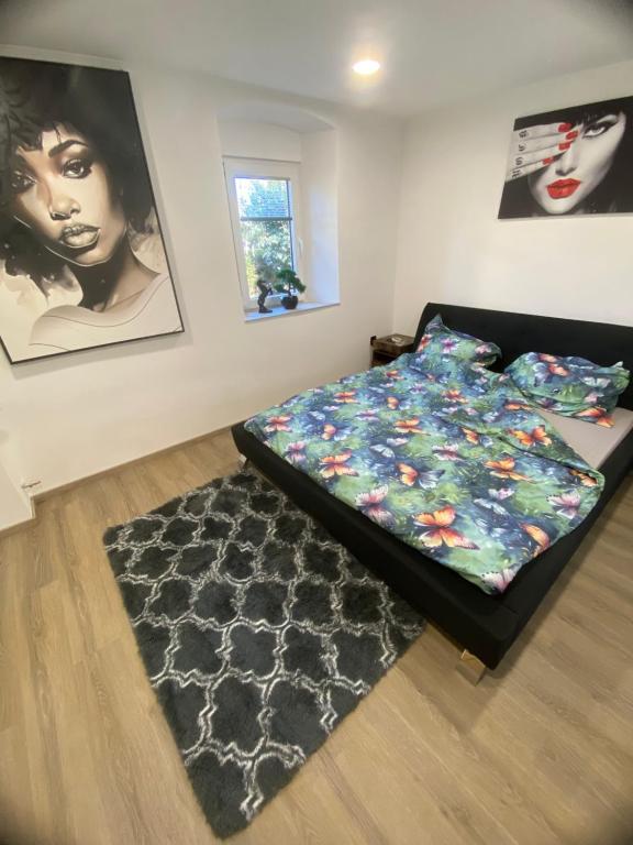 a bedroom with a bed and a rug at Apartmans Lars in Rečica ob Savinji