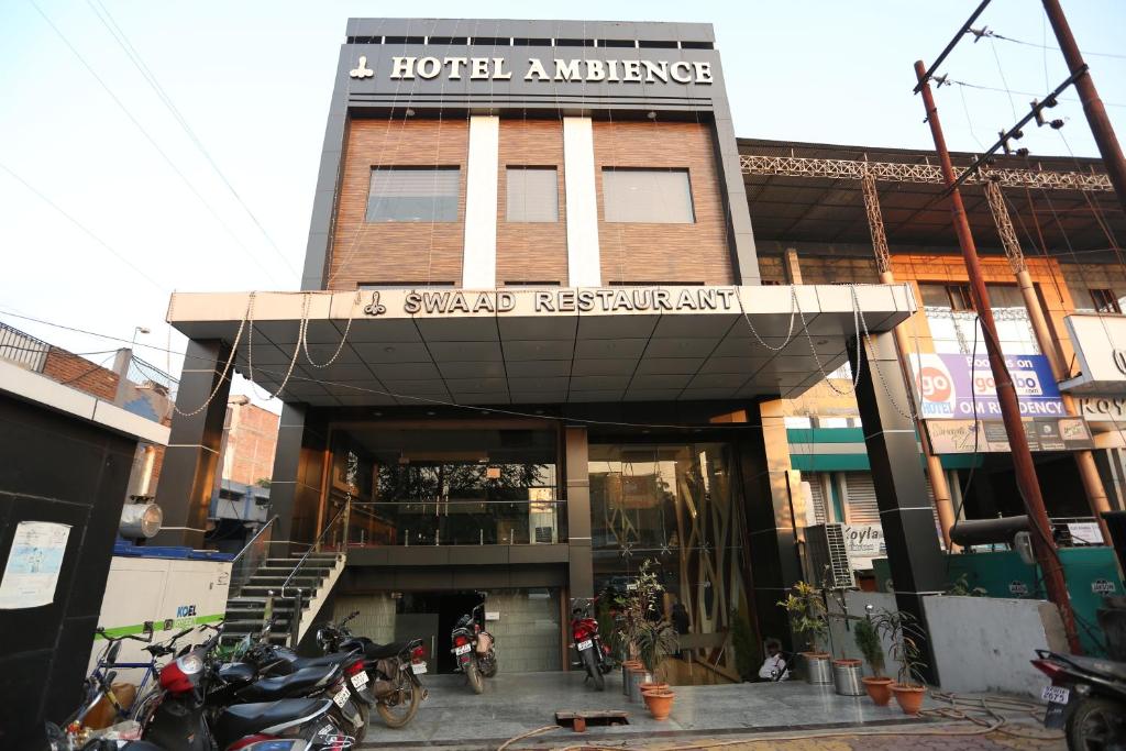 a hotel entrance with motorcycles parked in front of it at Hotel Ambience in Jhānsi