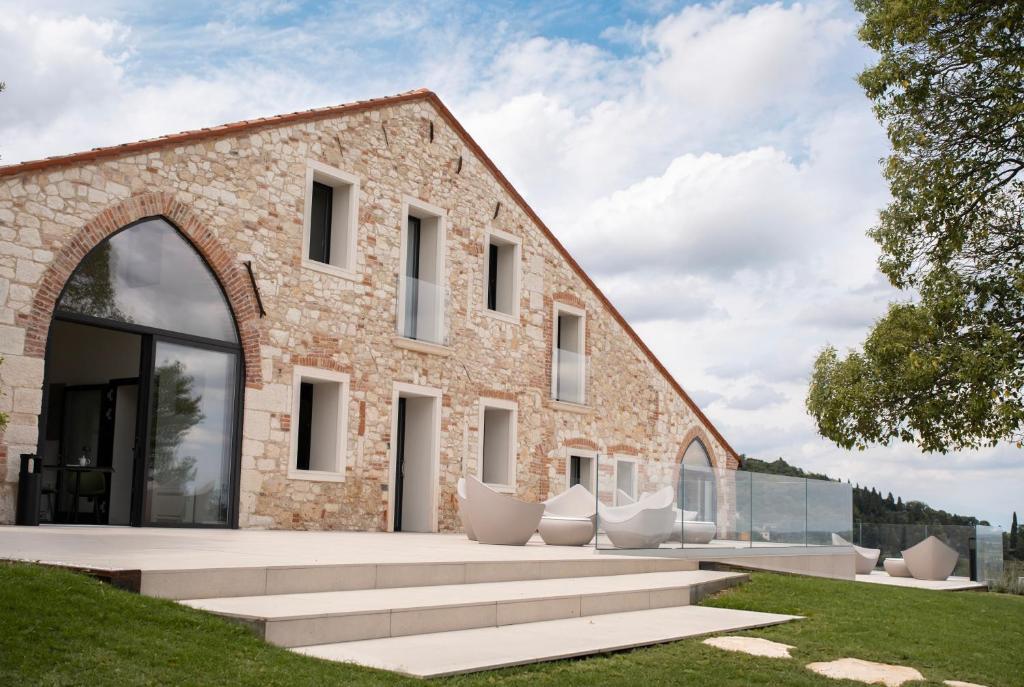 a brick building with a large window and lawn at Il Parnaso Relais in Longare