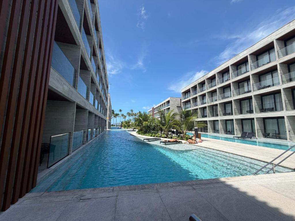 a swimming pool in the middle of a building at Gav Resorts in Ipojuca