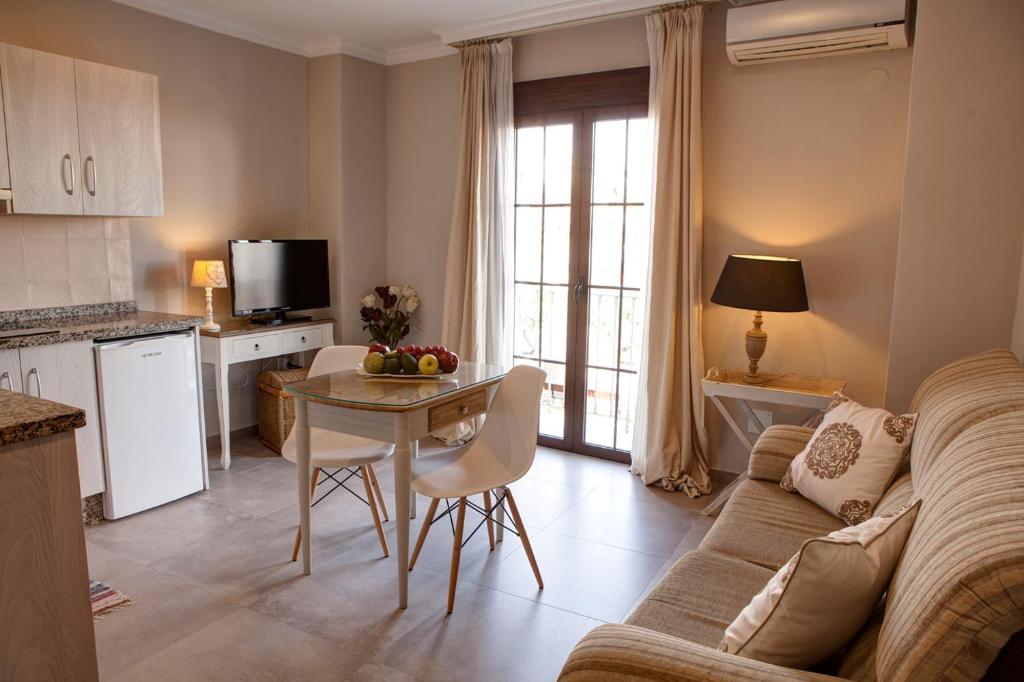 a living room with a couch and a table at Hostal Boutique Plaza Cantarero in Nerja