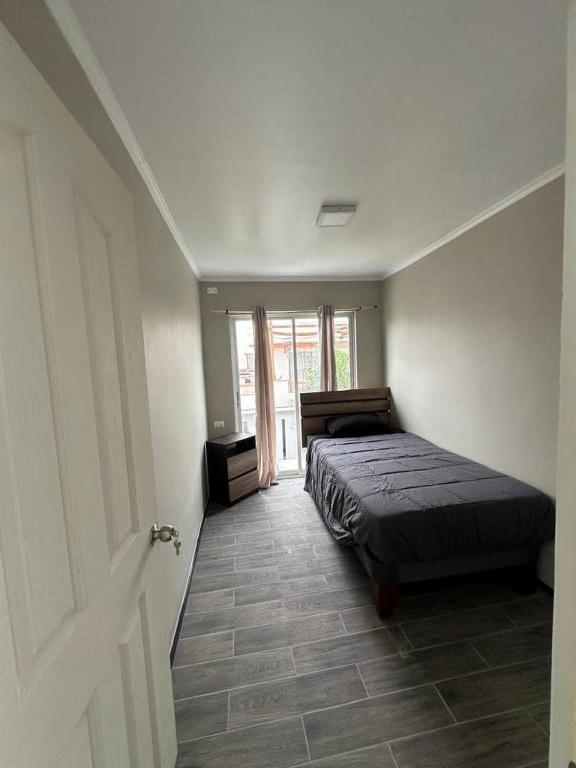 a bedroom with a bed in a room with a door at Casa & Habitaciones in Mejillones