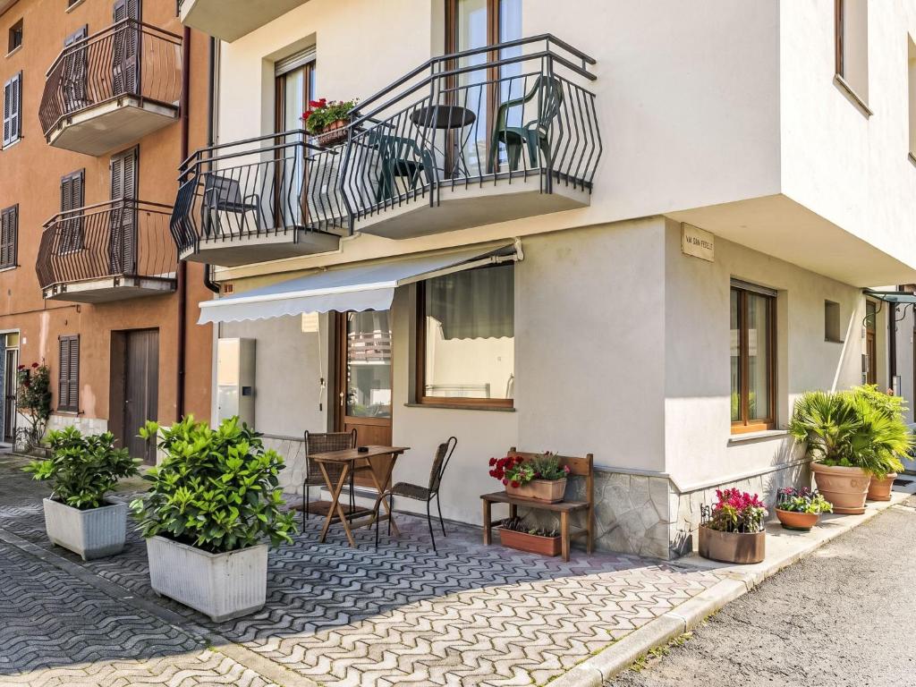 an apartment building with a table and a balcony at Holiday Home Mimi by Interhome in Verceia