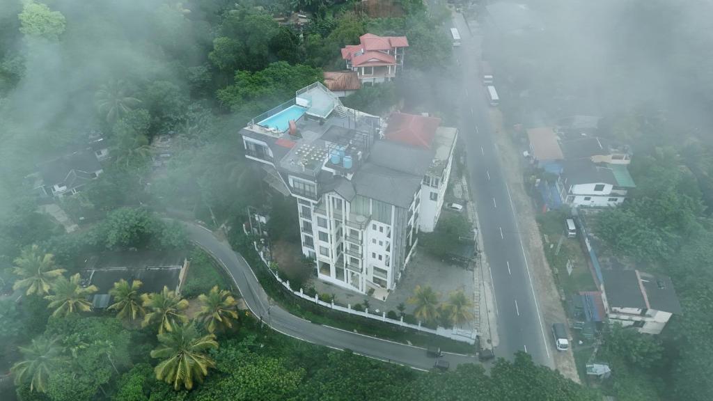an aerial view of a building in the fog at Rivendell Hotel in Kandy